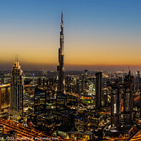 Buy canvas prints of Aerial illuminated Dubai at sunset Burj Khalifa UAE by Spotmatik 