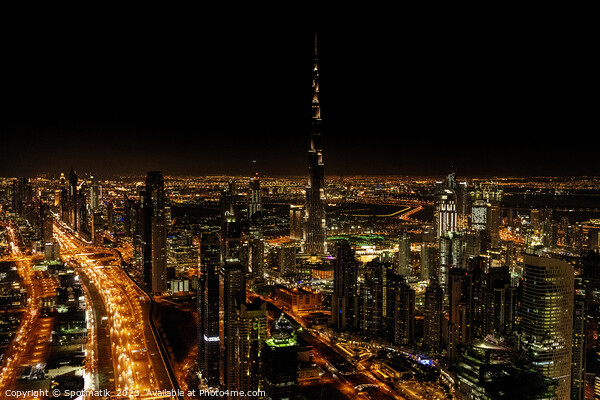 Aerial Dubai illuminated night view of Burj Khalifa  Picture Board by Spotmatik 