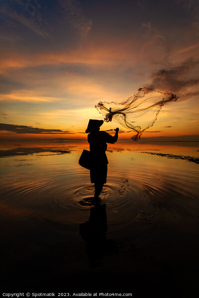 Balinese fisherman casting net Flores sea at sunrise Picture Board by Spotmatik 