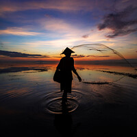 Buy canvas prints of Silhouette Balinese male fishing Indonesian coastline at sunrise by Spotmatik 
