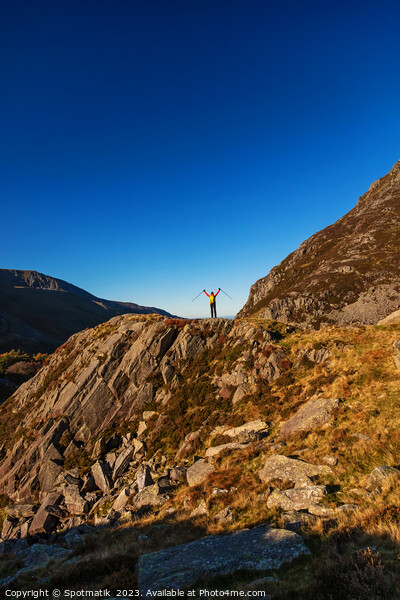 Happy female backpacker on rugged mountain peak Snowdonia Picture Board by Spotmatik 