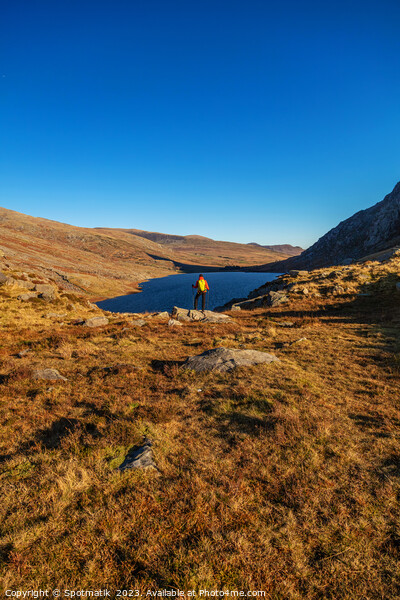 Lake in rural landscape with female backpacker Snowdonia Picture Board by Spotmatik 