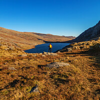 Buy canvas prints of Lake in rural landscape with female backpacker Snowdonia by Spotmatik 