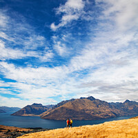 Buy canvas prints of Male female hikers viewing Lake Wakatipu New Zealand  by Spotmatik 
