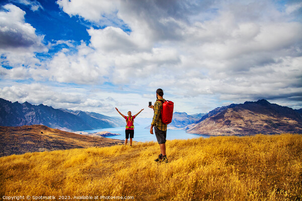 Backpacking young couple taking smartphone picture Lake Wakatipu  Picture Board by Spotmatik 