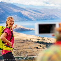 Buy canvas prints of Young male taking picture of happy female Queenstown by Spotmatik 