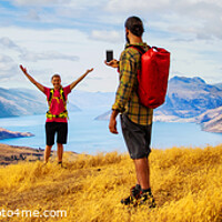 Buy canvas prints of Panorama of young backpacking couple taking smartphone photo  by Spotmatik 