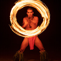 Buy canvas prints of French Polynesia Illuminated flaming torch male Fire dancer  by Spotmatik 