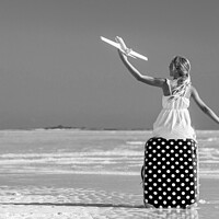 Buy canvas prints of Girl sitting on red travel luggage on beach plane by Spotmatik 