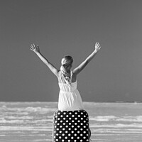 Buy canvas prints of Blonde female teenager on beach sitting on suitcase by Spotmatik 