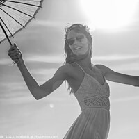 Buy canvas prints of Young American female dancing on beach with parasol by Spotmatik 