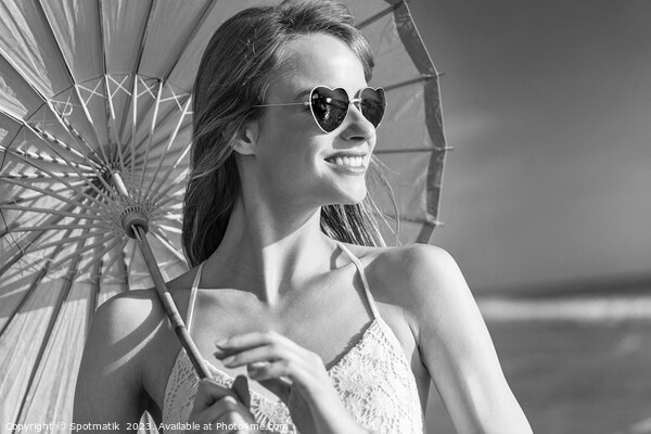 Smiling American hippy chic with parasol on beach Picture Board by Spotmatik 