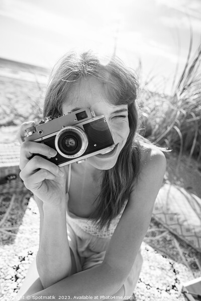Smiling Caucasian girl with retro camera photograph beach vacation Picture Board by Spotmatik 