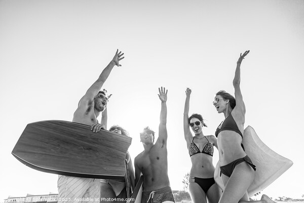 Friends in swimwear with bodyboards celebrating Summer vacation Picture Board by Spotmatik 