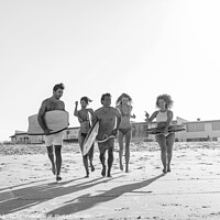 Buy canvas prints of Friends in swimwear running carrying bodyboards on beach by Spotmatik 