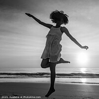 Buy canvas prints of Barefoot young African American woman dancing on beach by Spotmatik 