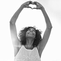Buy canvas prints of Afro American girl showing heart sign with hands by Spotmatik 