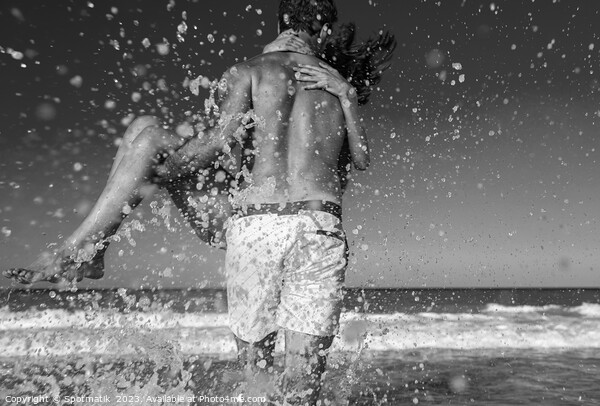 Fun loving ethnic couple running in ocean waves Picture Board by Spotmatik 