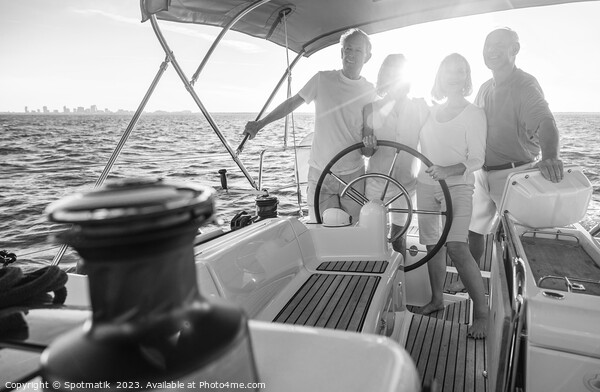 Senior friends enjoying retirement steering yacht at sunset Picture Board by Spotmatik 