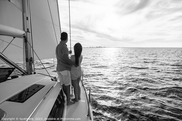 Hispanic couple travelling on luxury yacht at sunset Picture Board by Spotmatik 