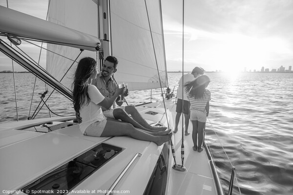 Young family having fun on yacht at sunset Picture Board by Spotmatik 