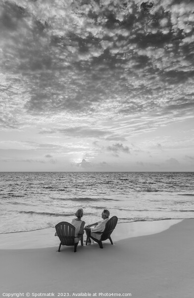 Retired Caucasian couple on beach at sunset Bahamas Picture Board by Spotmatik 