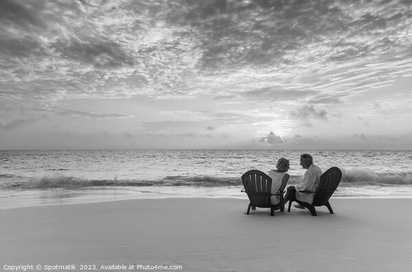 Mature couple enjoying ocean sunset on beach Bahamas Picture Board by Spotmatik 