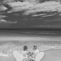 Buy canvas prints of Mature couple on white chairs by ocean Bahamas by Spotmatik 