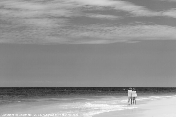 Retired couple walking barefoot by turquoise ocean Bahamas Picture Board by Spotmatik 