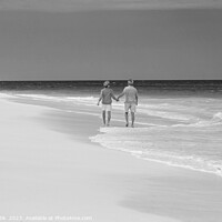 Buy canvas prints of Mature couple paddling on tropical island shoreline Bahamas by Spotmatik 