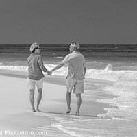 Buy canvas prints of Panoramic beach view with retired couple holding hands by Spotmatik 