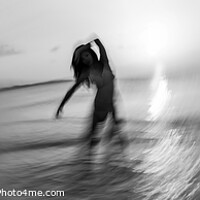 Buy canvas prints of Panoramic ocean sunset with dancing female motion blur by Spotmatik 