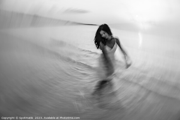 Motion blurred dancing Asian girl in ocean sunset Picture Board by Spotmatik 