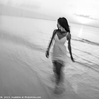 Buy canvas prints of Motion blurred woman walking through waves at sunset by Spotmatik 