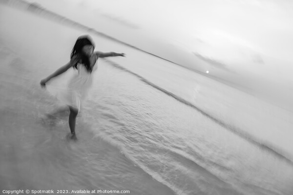 Motion blur carefree Asian female dancing on shoreline Picture Board by Spotmatik 