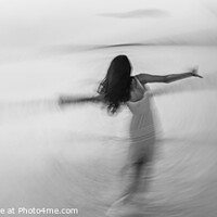 Buy canvas prints of Motion blurred panoramic ocean sunset with dancing girl by Spotmatik 