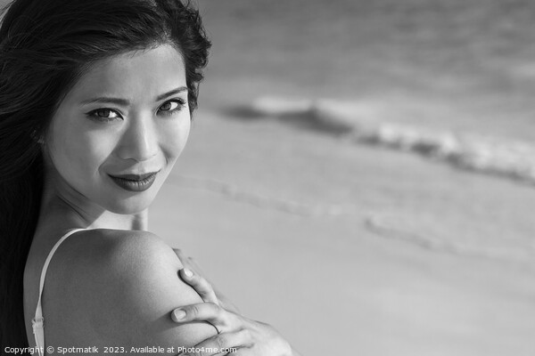 Portrait of smiling Asian woman by ocean waves Picture Board by Spotmatik 