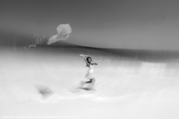 Motion blurred young woman flying kite on beach Picture Board by Spotmatik 