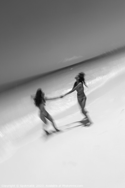 Motion blurred women in swimwear playing by ocean Picture Board by Spotmatik 