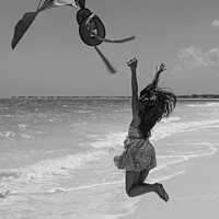 Buy canvas prints of Happy Asian girl jumping by ocean flying kite by Spotmatik 