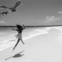 Buy canvas prints of Motion blurred woman jumping on beach flying kite by Spotmatik 