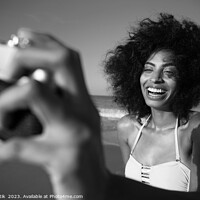 Buy canvas prints of Laughing African American girl taking selfie on beach by Spotmatik 