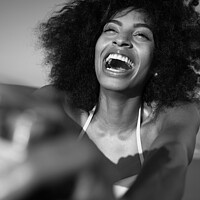 Buy canvas prints of Laughing African American woman taking selfie on beach by Spotmatik 