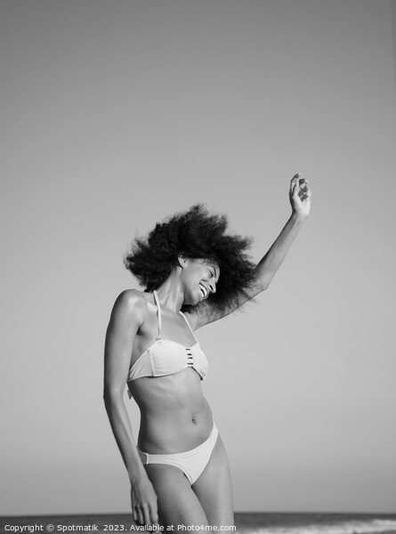 Afro girl in swimwear dancing on the beach Picture Board by Spotmatik 