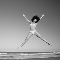 Buy canvas prints of Happy African American girl jumping by the ocean by Spotmatik 