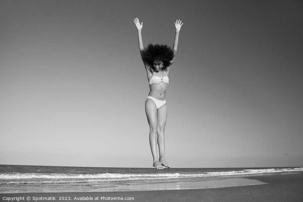 Afro American woman in swimwear jumping for joy Picture Board by Spotmatik 