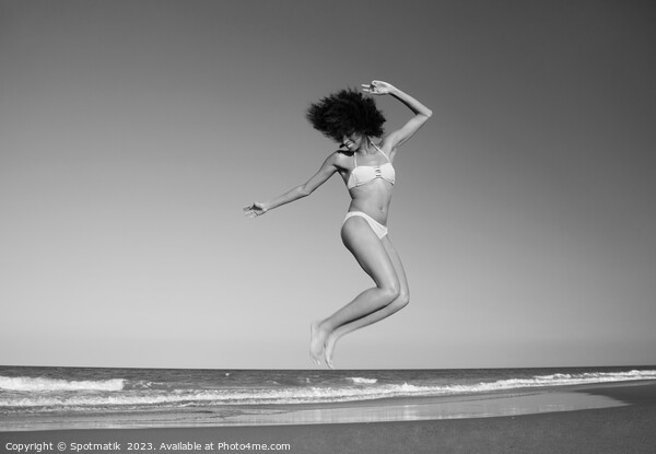 Afro American woman jumping for joy on beach Picture Board by Spotmatik 