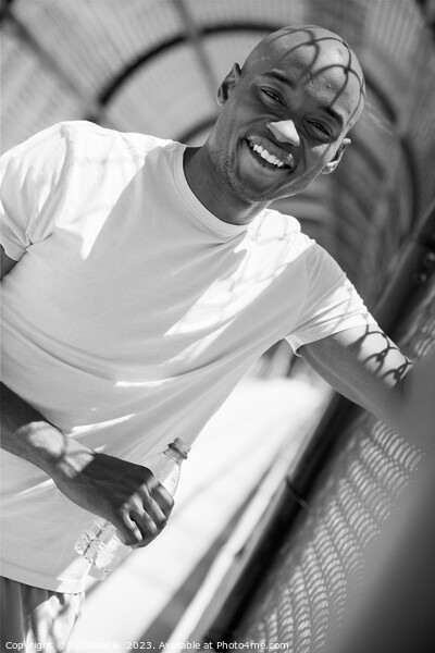 Portrait of African American male with water bottle Picture Board by Spotmatik 