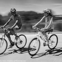Buy canvas prints of African American couple keeping fit riding bikes together by Spotmatik 