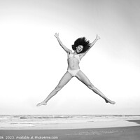 Buy canvas prints of Healthy African American girl jumping high on beach by Spotmatik 